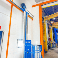 Wall-Man material handling system integrated into an industrial paint booth